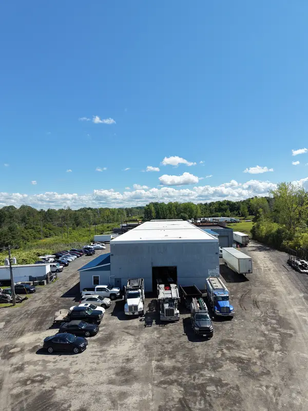 Aerial of the Top Guns shop on Walters Rd with trucks at the bay door and cars in the lot.